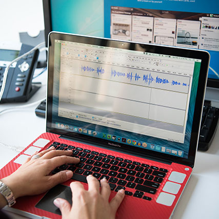 Photograph of woman's hands with laptop.